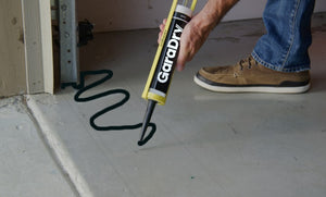 GaraDry Adhesive being applied to the floor to prepare for threshold seal
