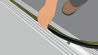 Illustration of a man putting the top seal into the 25mm commercial door threshold seal to install