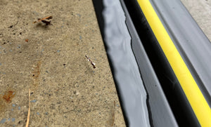 Close up of a 15mm garage door threshold seal stopping water and debris