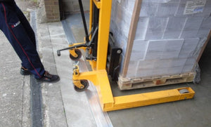 Moving a pallet stacker over the industrial strength aluminium threshold seal showing its durability